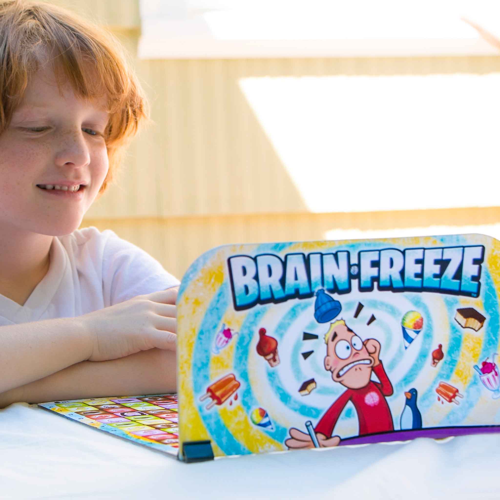 Kids Playing Brain Freeze Strategy board game by Mighty Fun! Ages 5 up.