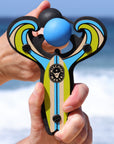 Blue Surf’s Up toy slingshot being launched by the ocean. Mischief Maker by Mighty Fun!