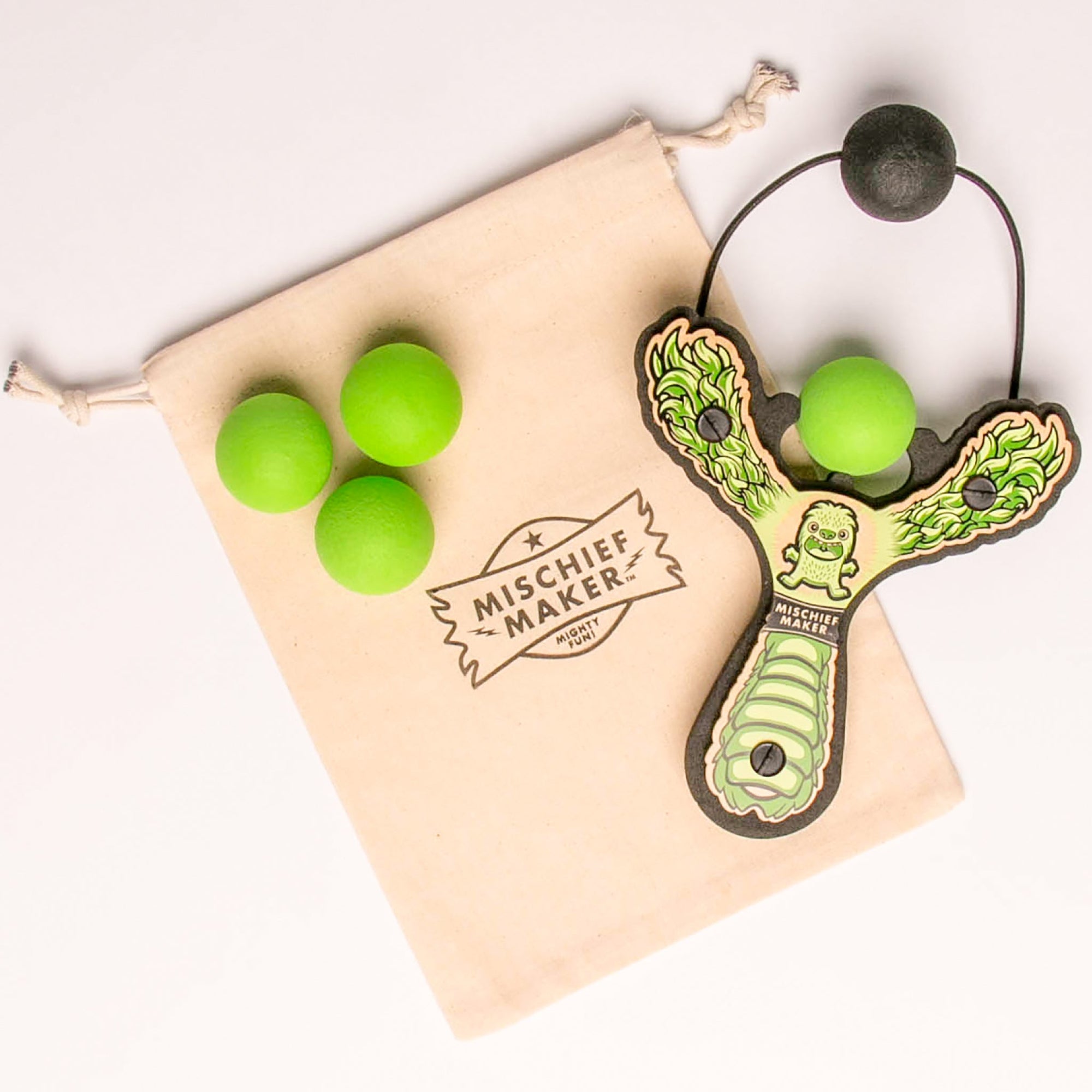 Green Monster toy slingshot with 4 soft foam balls and storage bag. Mischief Maker by Mighty Fun!