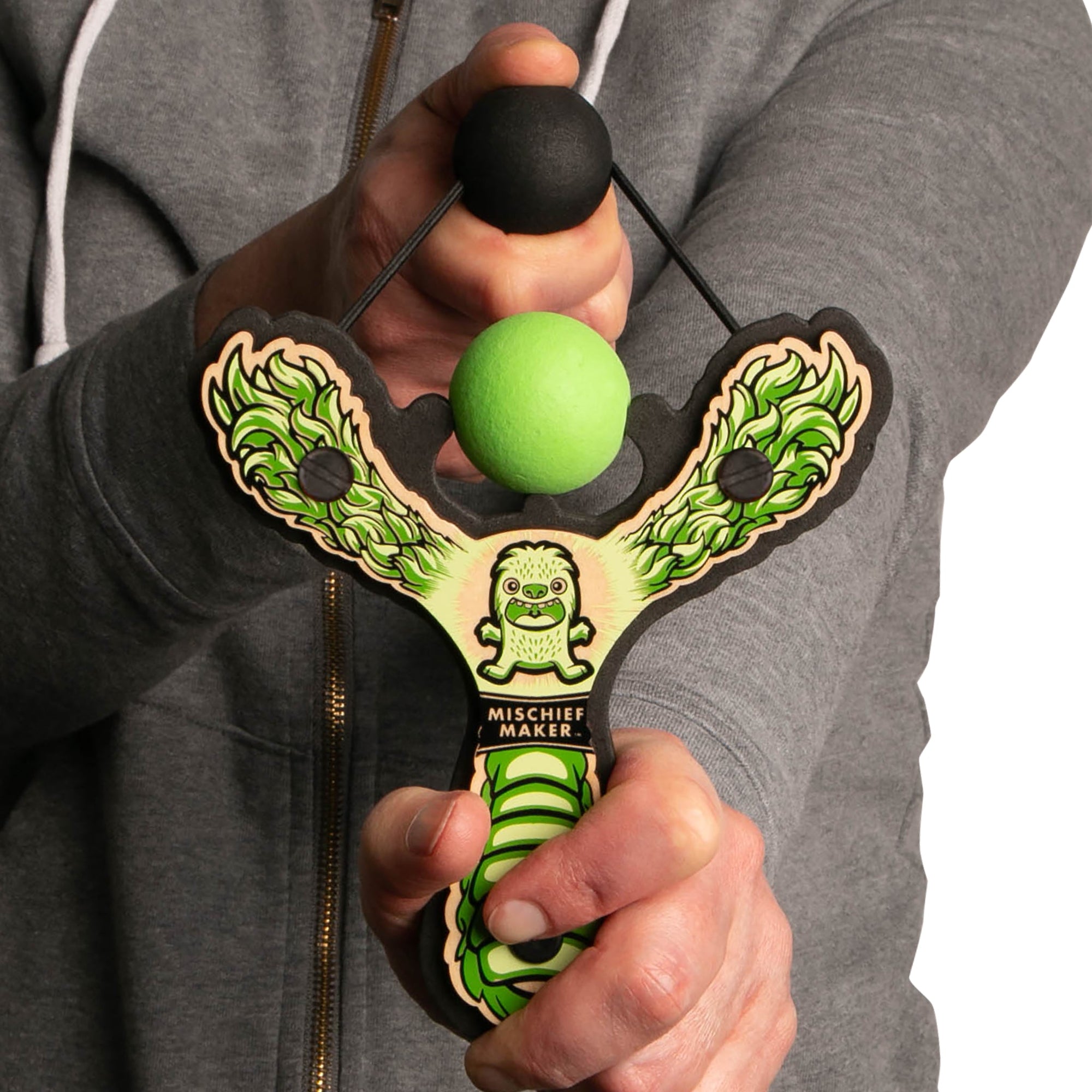 Green Monster toy slingshot being shot by 6 year old boy. Mischief Maker by Mighty Fun!