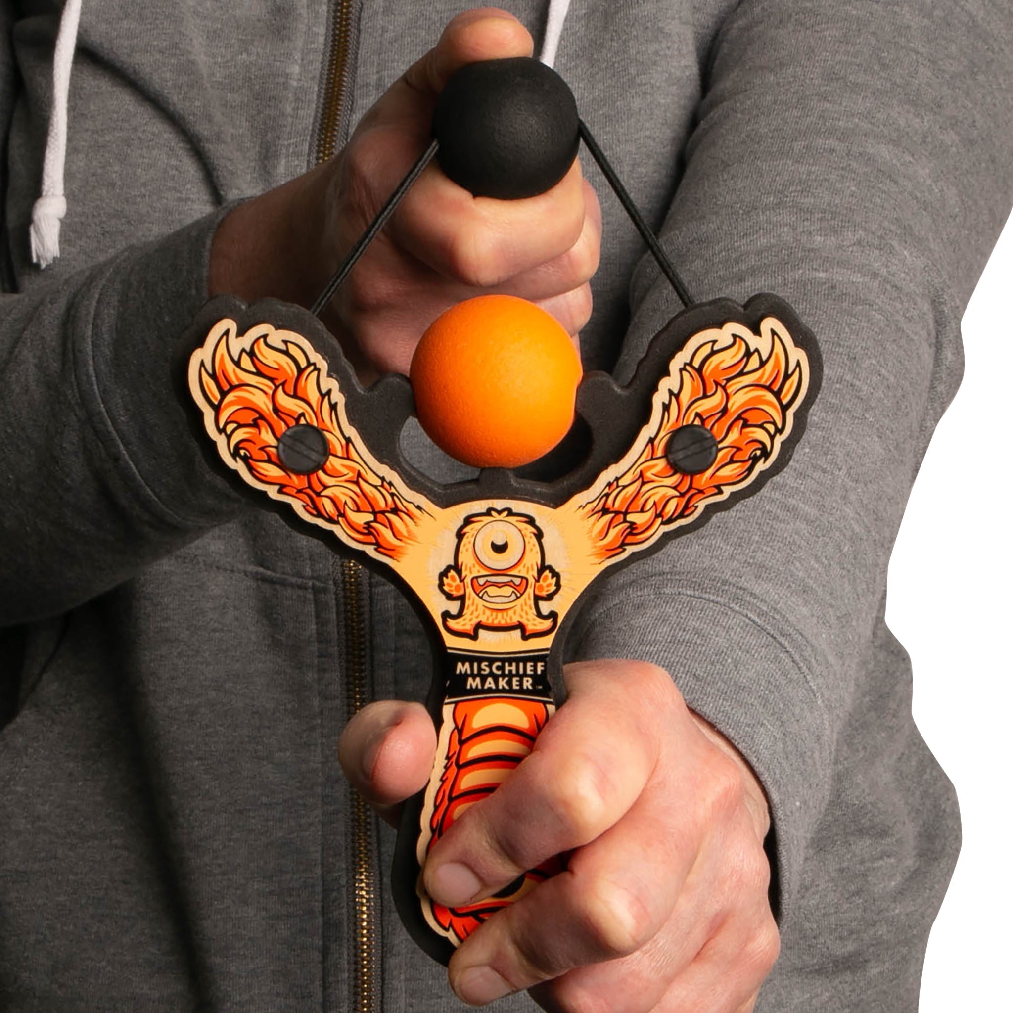 Orange Monster toy slingshot being shot by 6 year old boy. Mischief Maker by Mighty Fun! 