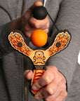 Orange Monster toy slingshot being shot by 6 year old boy. Mischief Maker by Mighty Fun! 