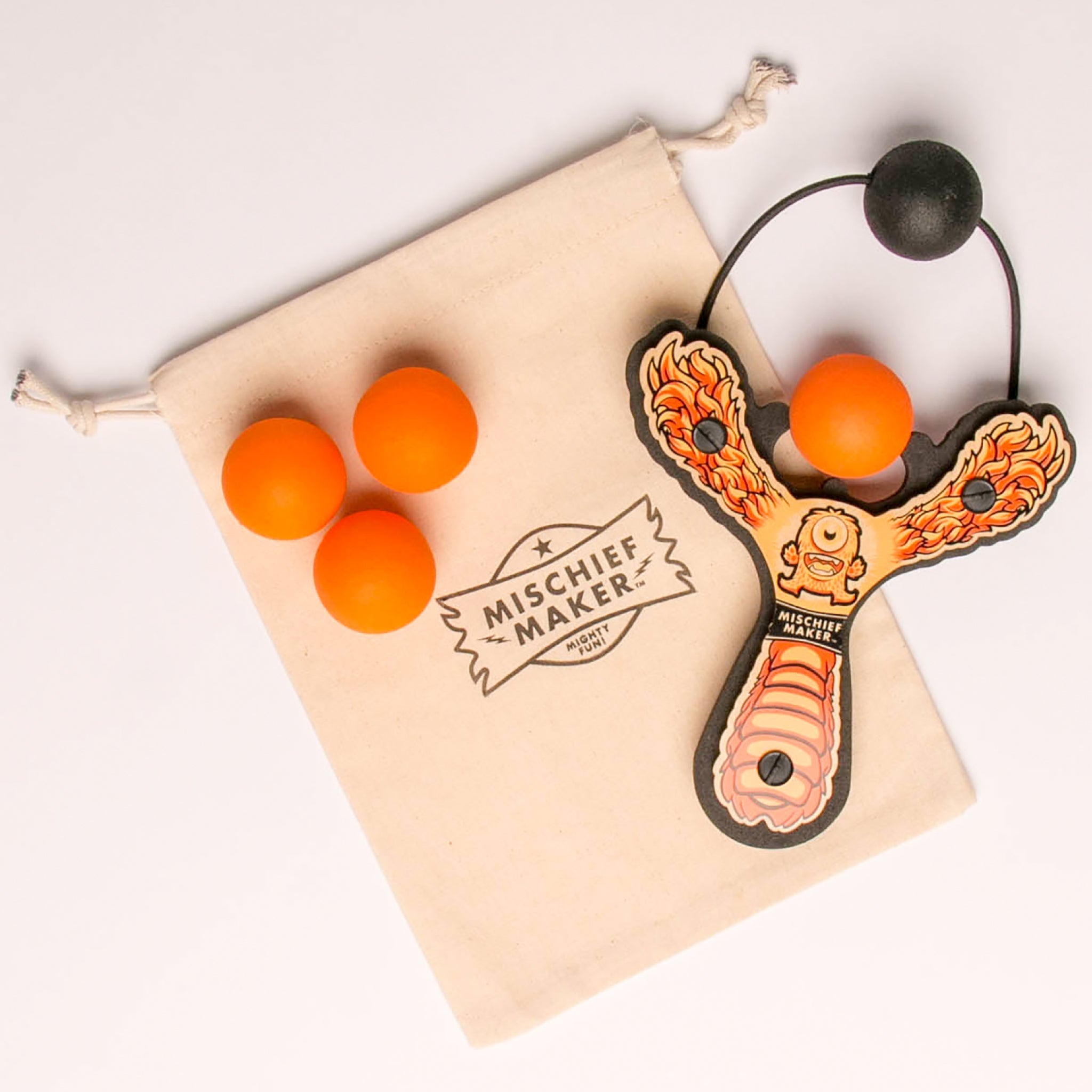 Orange Monster toy slingshot with 4 soft foam balls and storage bag. Mischief Maker by Mighty Fun!