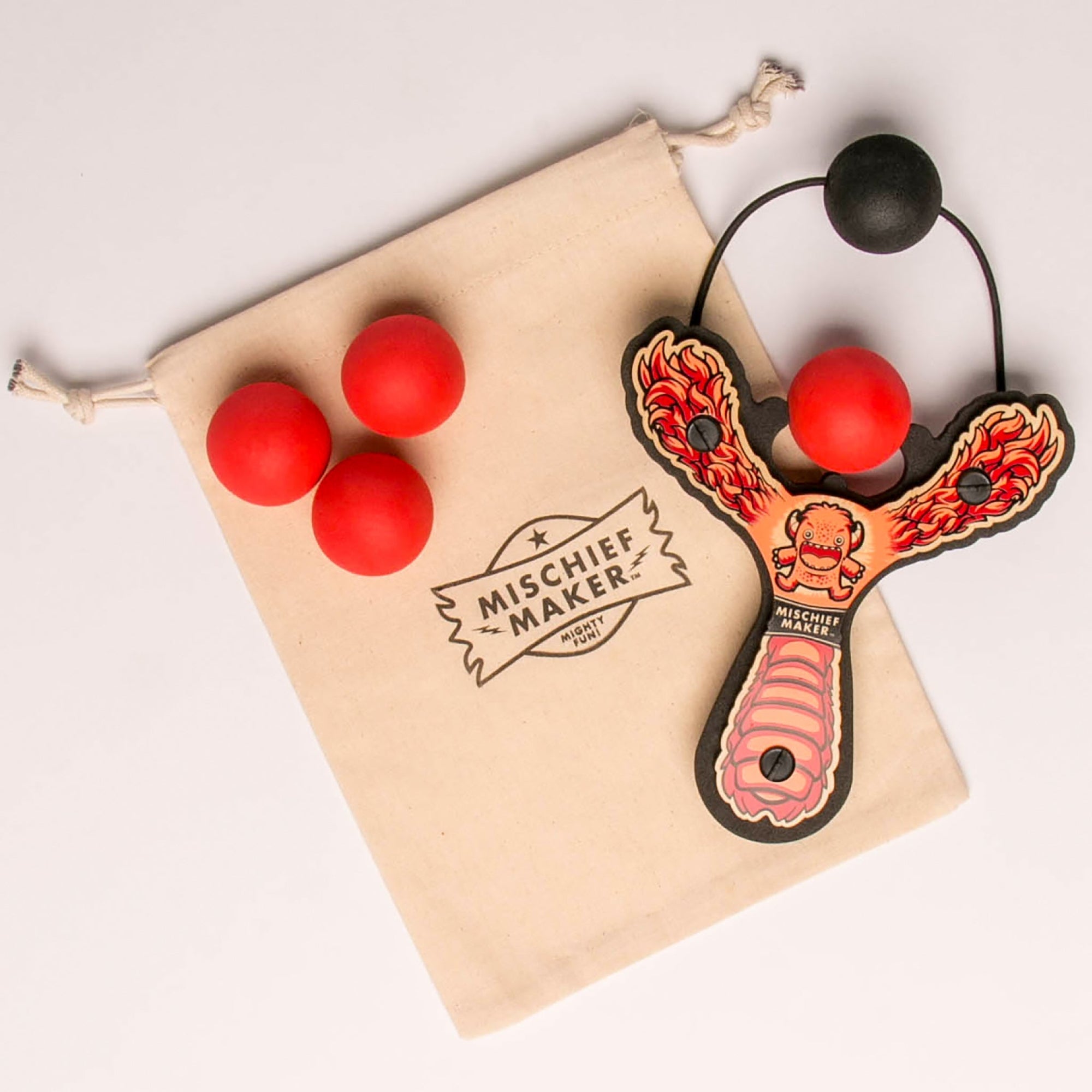 Red Monster toy slingshot with 4 soft foam balls and storage bag. Mischief Maker by Mighty Fun!