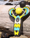 Yellow Surf’s Up toy slingshot with ball foam ball by the ocean. Mischief Maker by Mighty Fun!