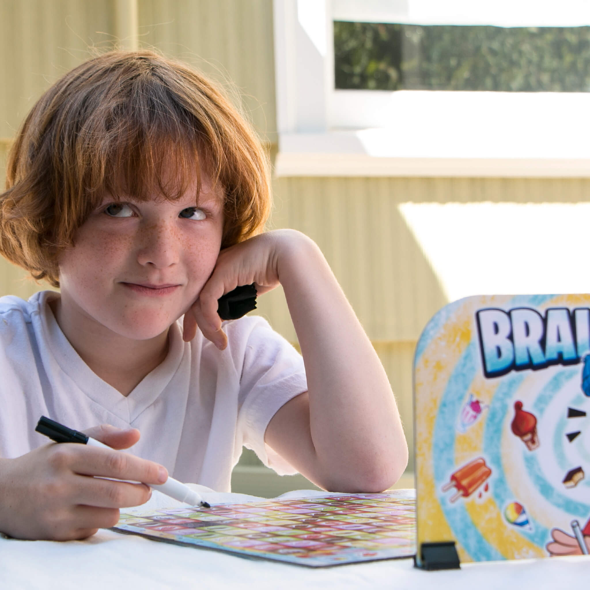 Kids Playing Brain Freeze Strategy board game by Mighty Fun! Ages 5 up.