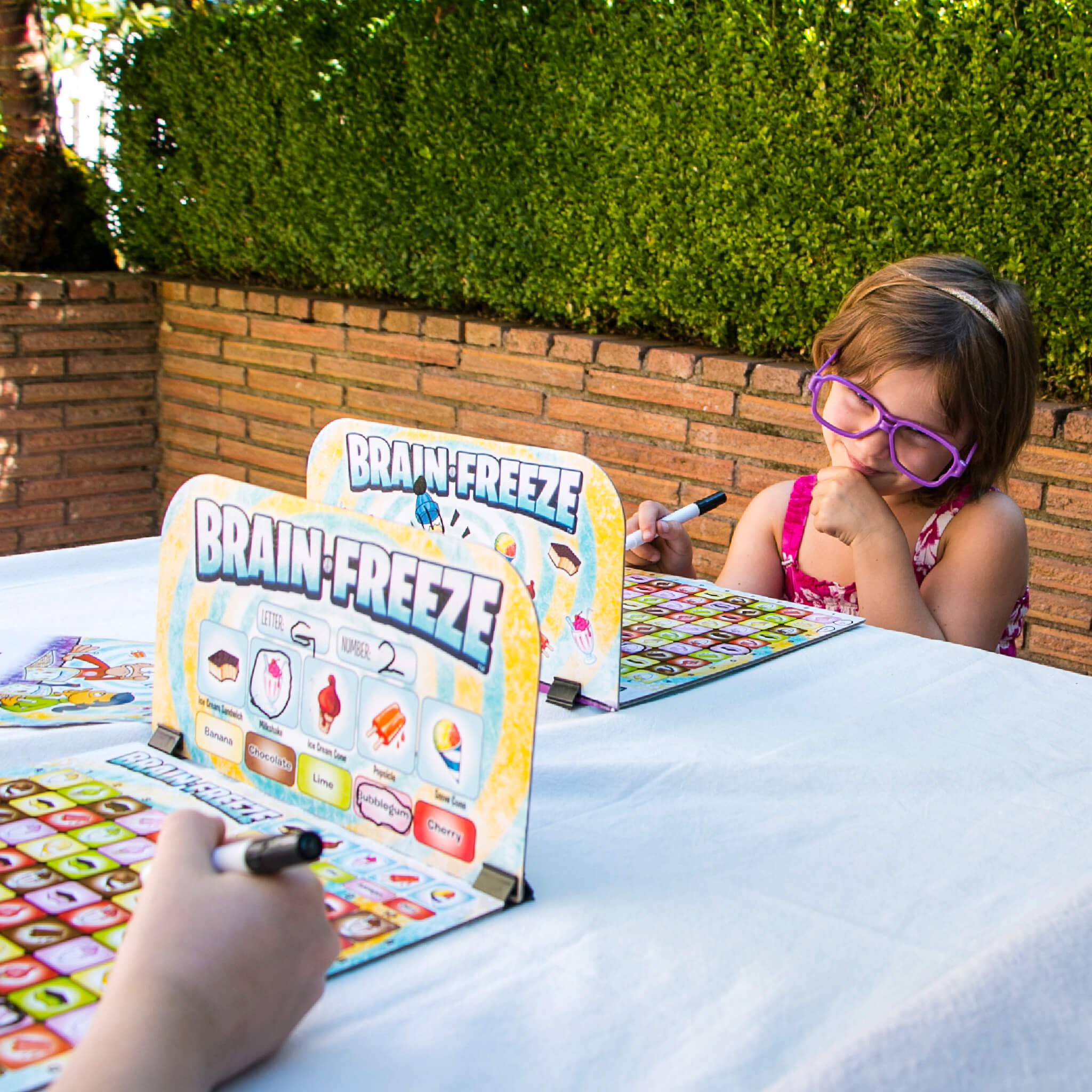 Kids Playing Brain Freeze Strategy board game by Mighty Fun! Ages 5 up.