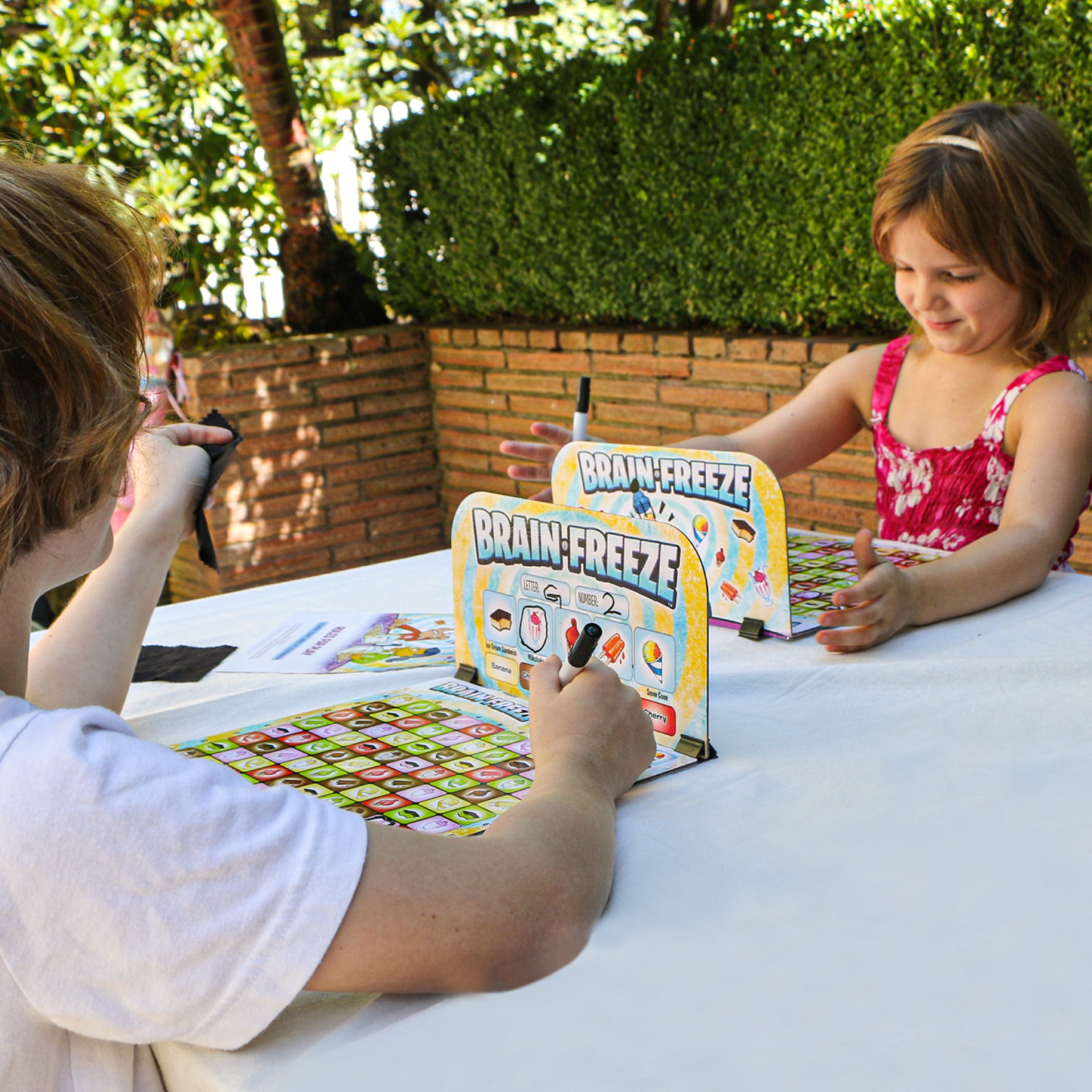 Kids Playing Brain Freeze Strategy board game by Mighty Fun! Ages 5 up.