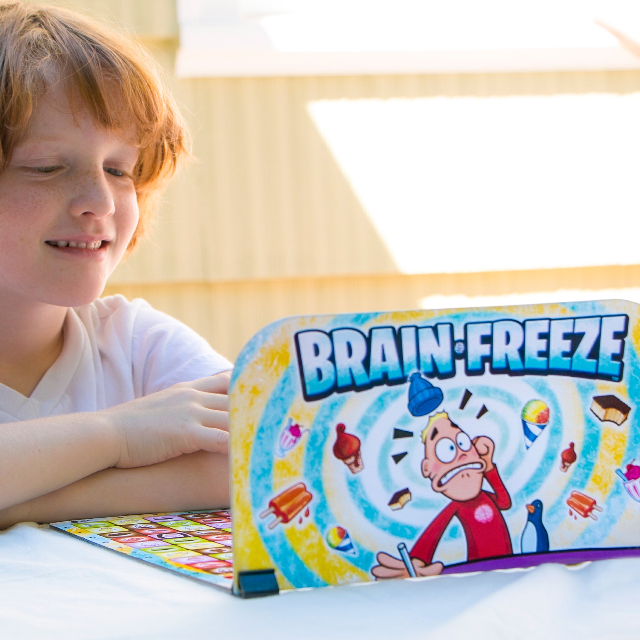 Kids Playing Brain Freeze Strategy board game by Mighty Fun! Ages 5 up.