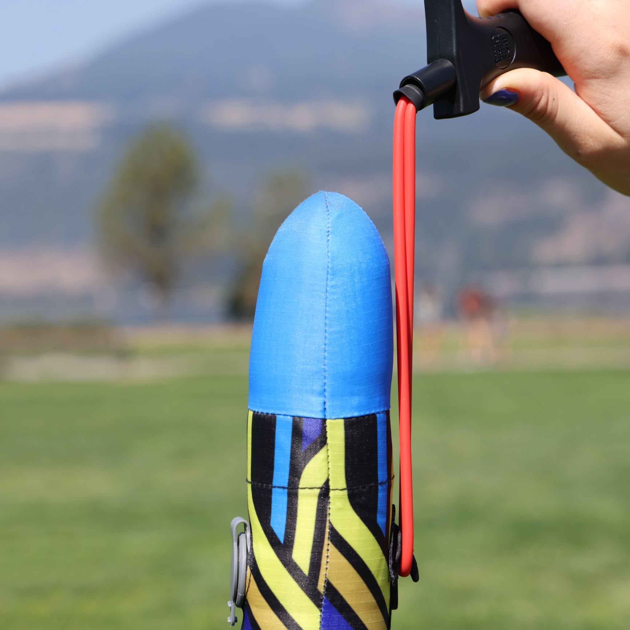 Blue Airo Rocket toy rocket being launched outside. By Mighty Fun!