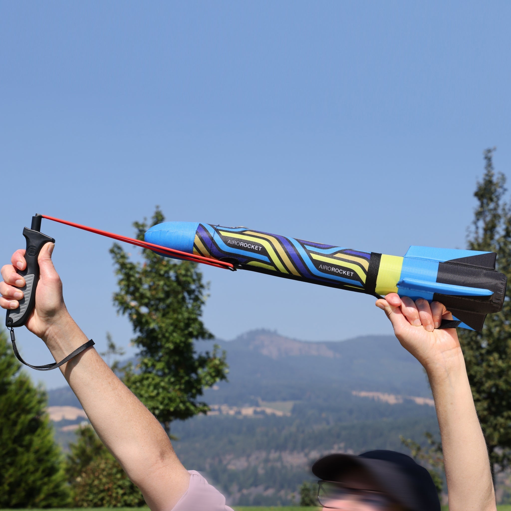 Blue Airo Rocket toy rocket being launched outside. By Mighty Fun!