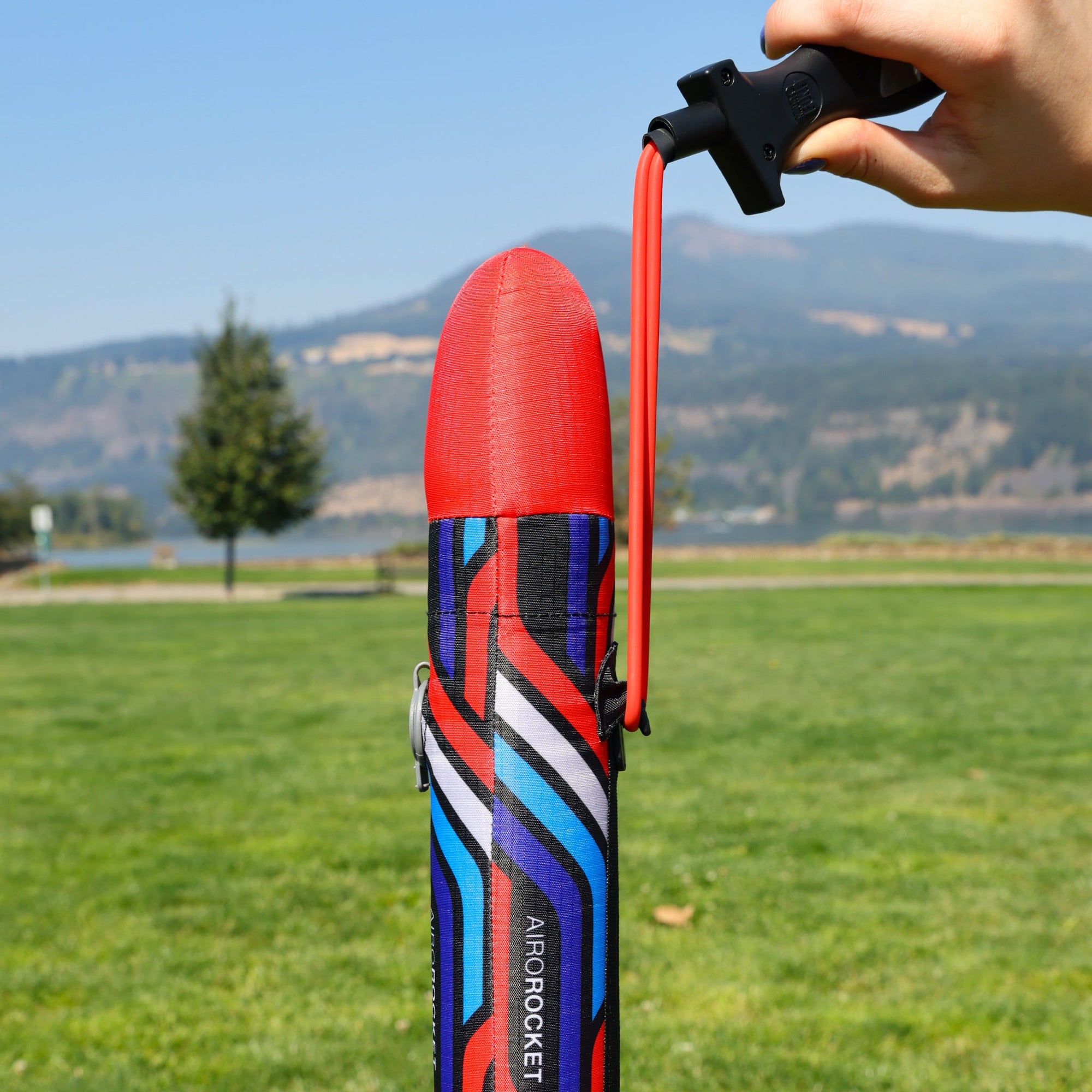 Red Airo Rocket toy rocket being launched outside. By Mighty Fun!