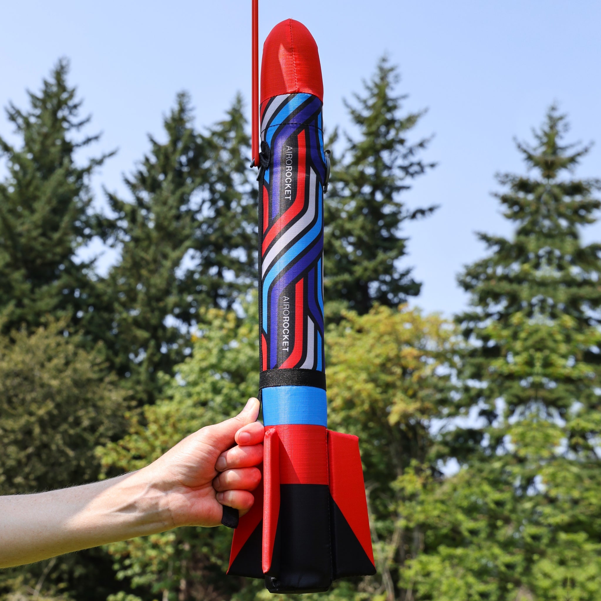 Red Airo Rocket toy rocket being launched outside. By Mighty Fun!