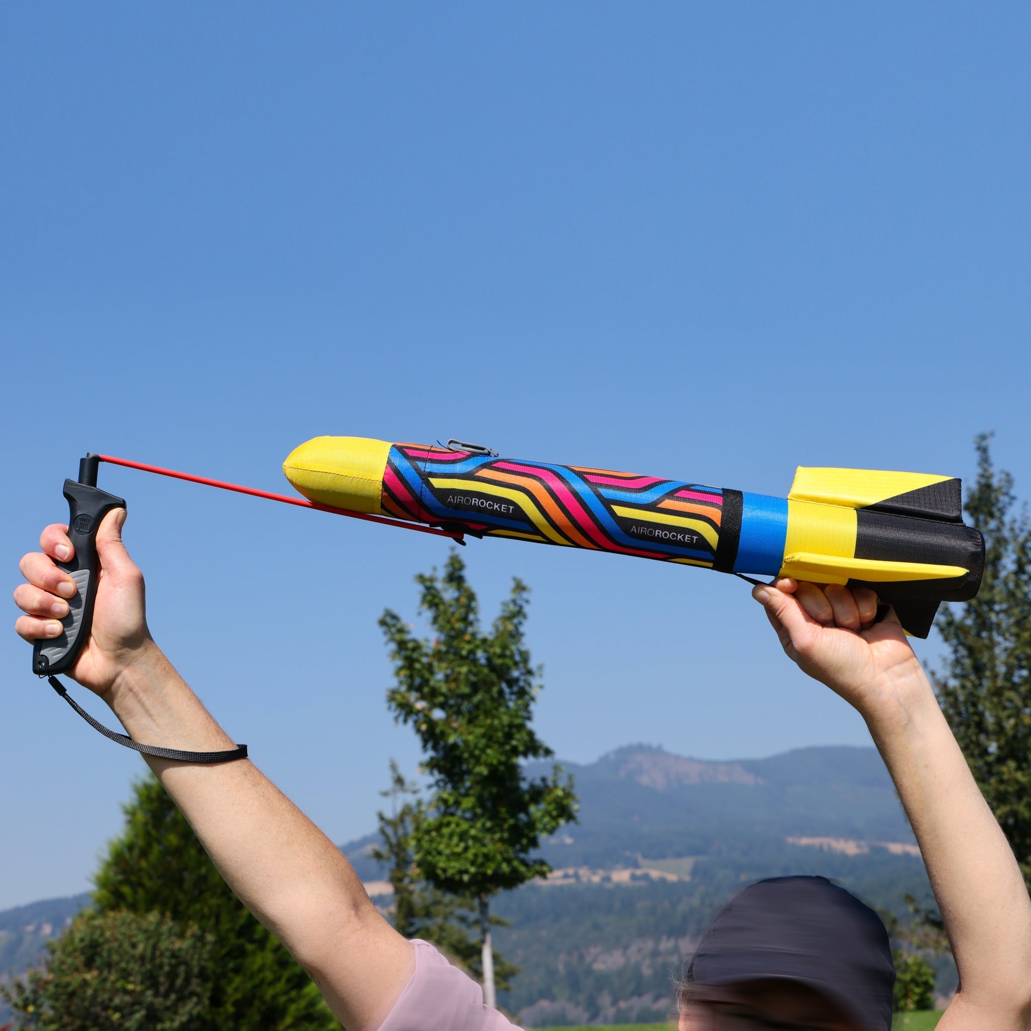Yellow Airo Rocket toy rocket being launched outside. By Mighty Fun!