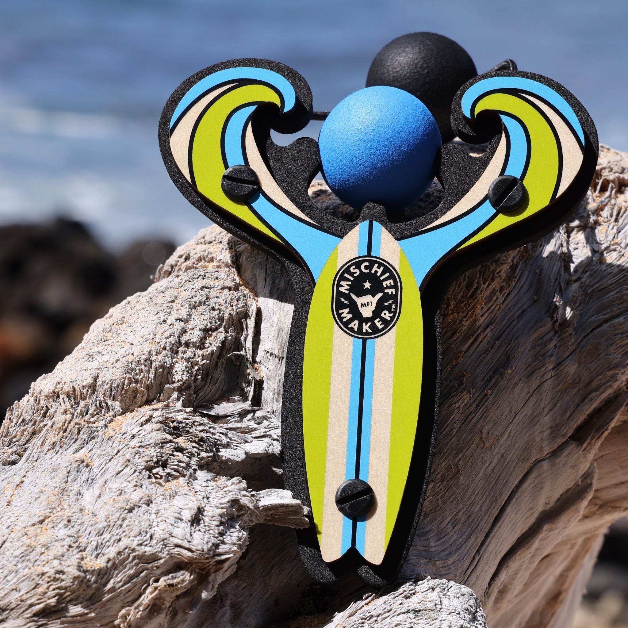 Blue Surf’s Up toy slingshot with ball foam ball by the ocean. Mischief Maker by Mighty Fun!