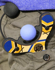 Blue classic wooden Mischief Maker kids toy slingshot in kid’s pocket. By Mighty Fun!
