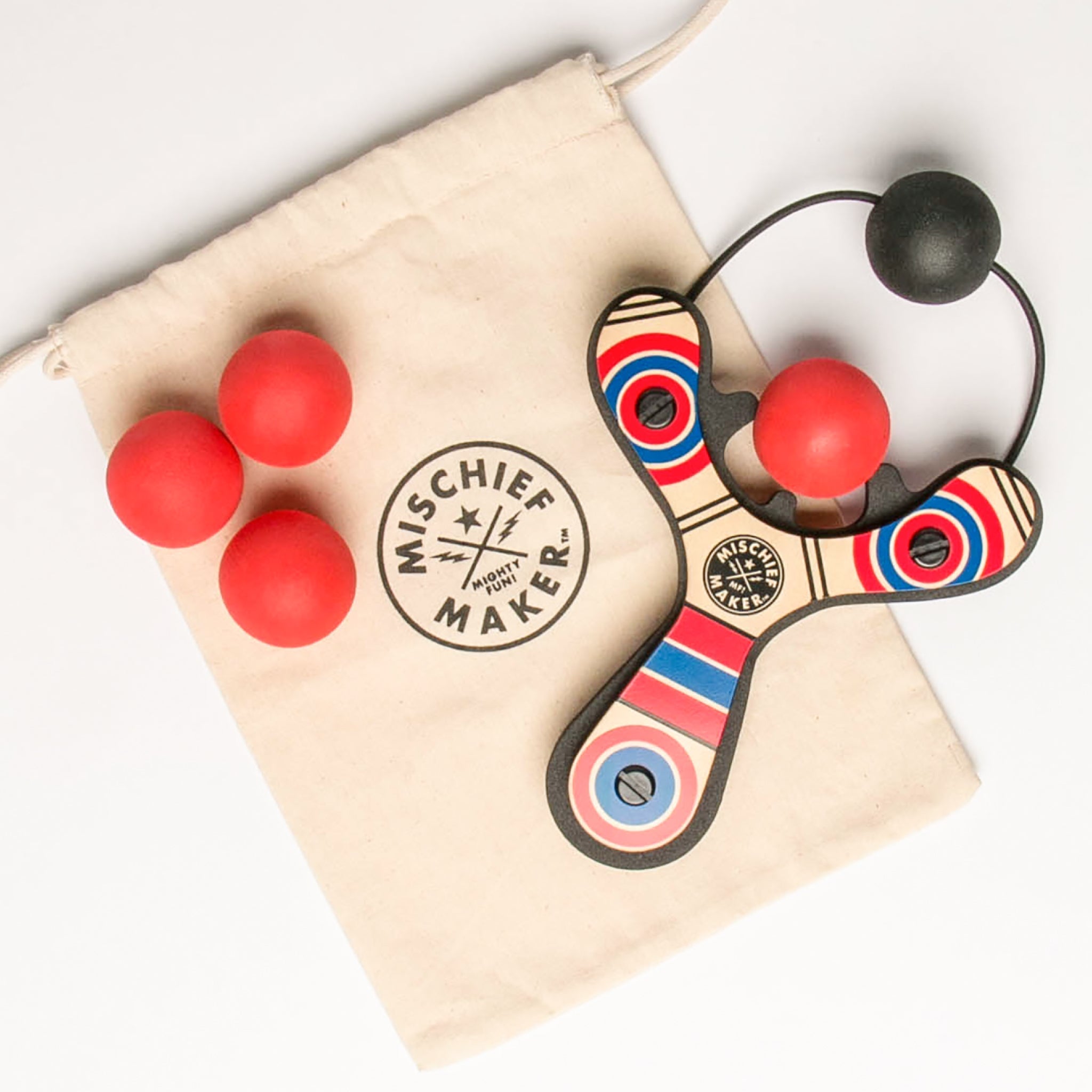 Red Classic wood slingshot with 4 soft foam balls and storage bag. Mischief Maker by Mighty Fun!
