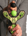 Green Monster toy slingshot being shot by 6 year old boy. Mischief Maker by Mighty Fun!