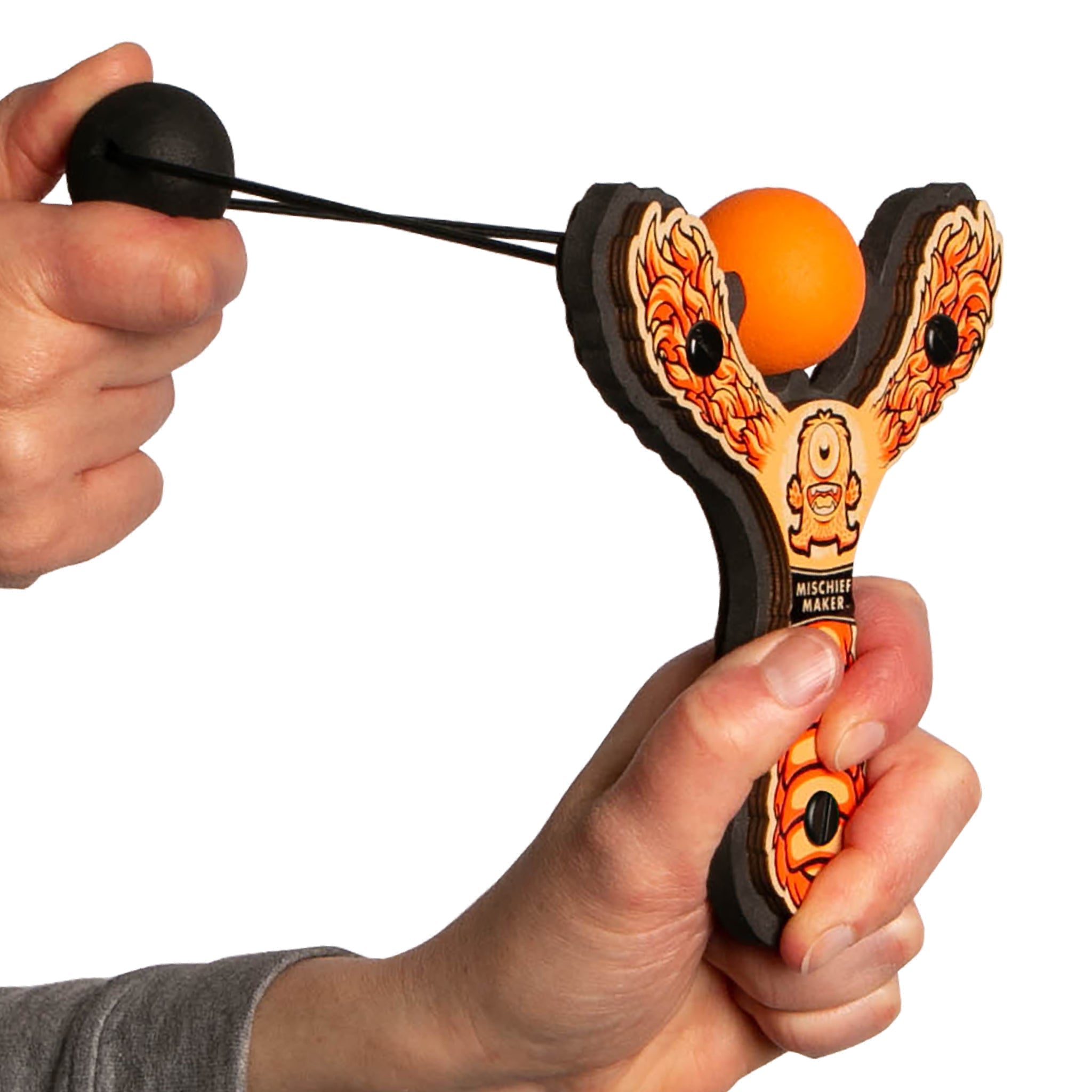 Orange Monster toy slingshot being launched. Mischief Maker by Mighty Fun!