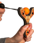 Orange Monster toy slingshot being launched. Mischief Maker by Mighty Fun!