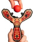 Red Monster toy slingshot being loaded with a soft foam ball. Mischief Maker by Mighty Fun!