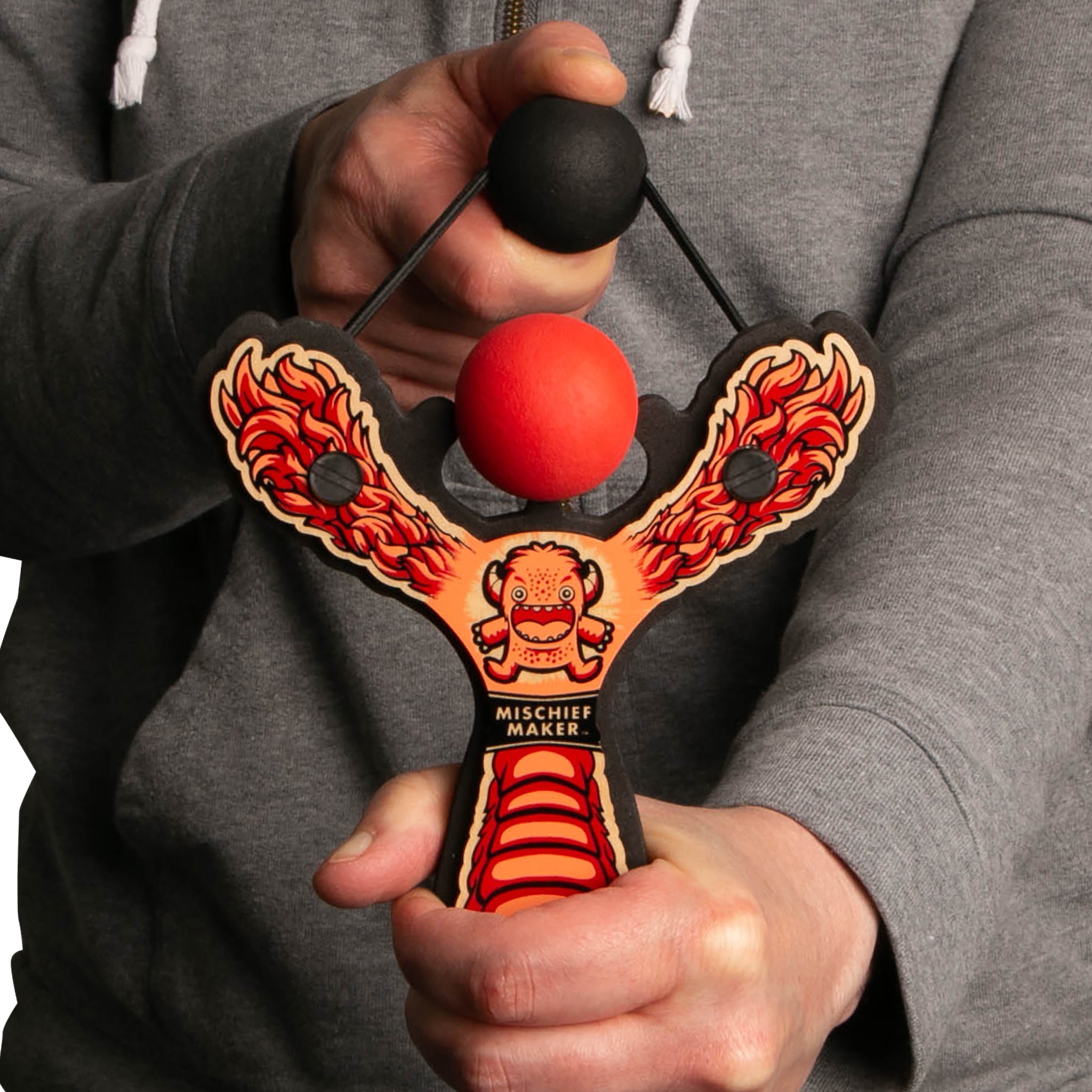 Red Monster toy slingshot being shot by 6 year old boy. Mischief Maker by Mighty Fun!