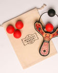 Red Monster toy slingshot with 4 soft foam balls and storage bag. Mischief Maker by Mighty Fun!
