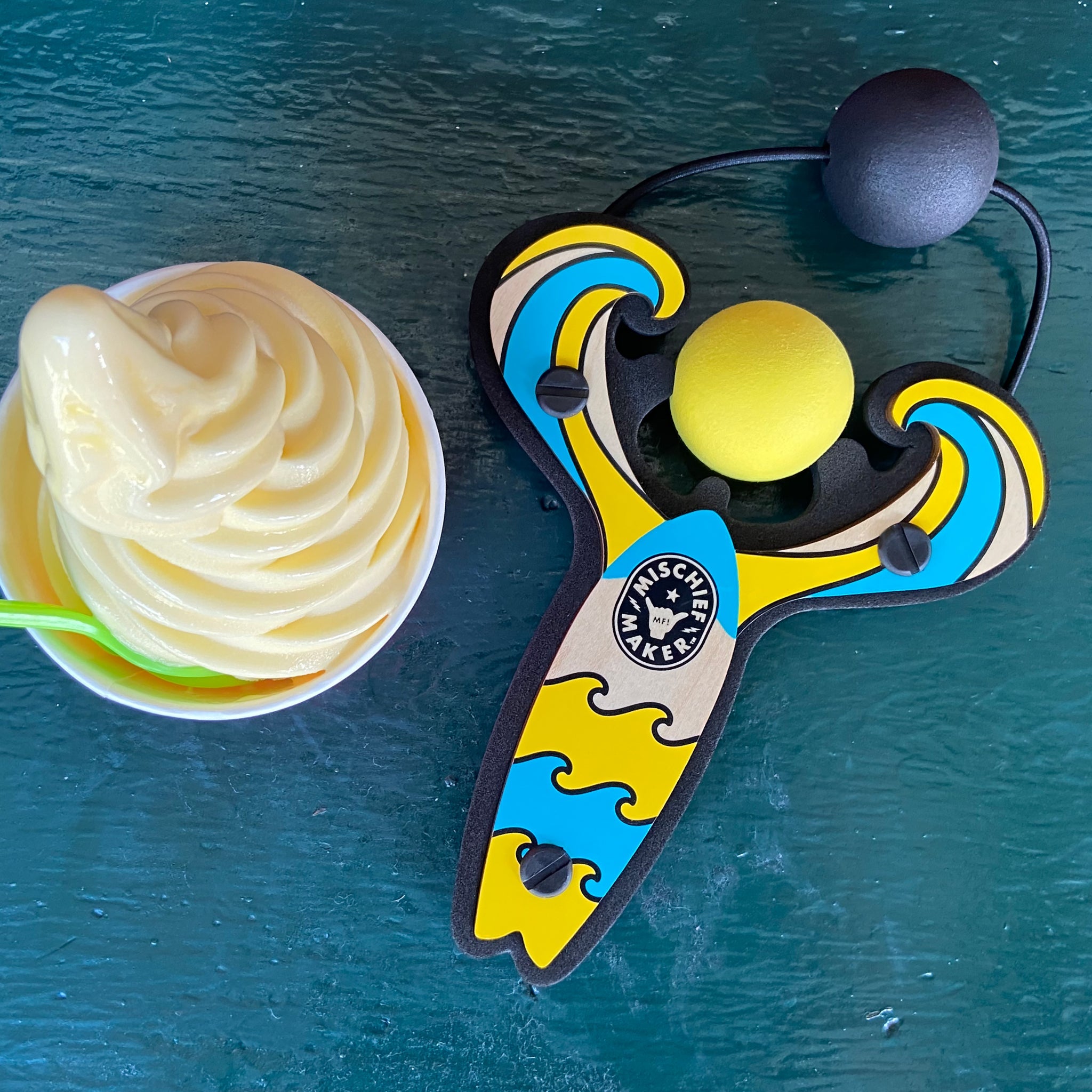 Yellow Surf’s Up toy slingshot with frozen yogurt. Mischief Maker by Mighty Fun!